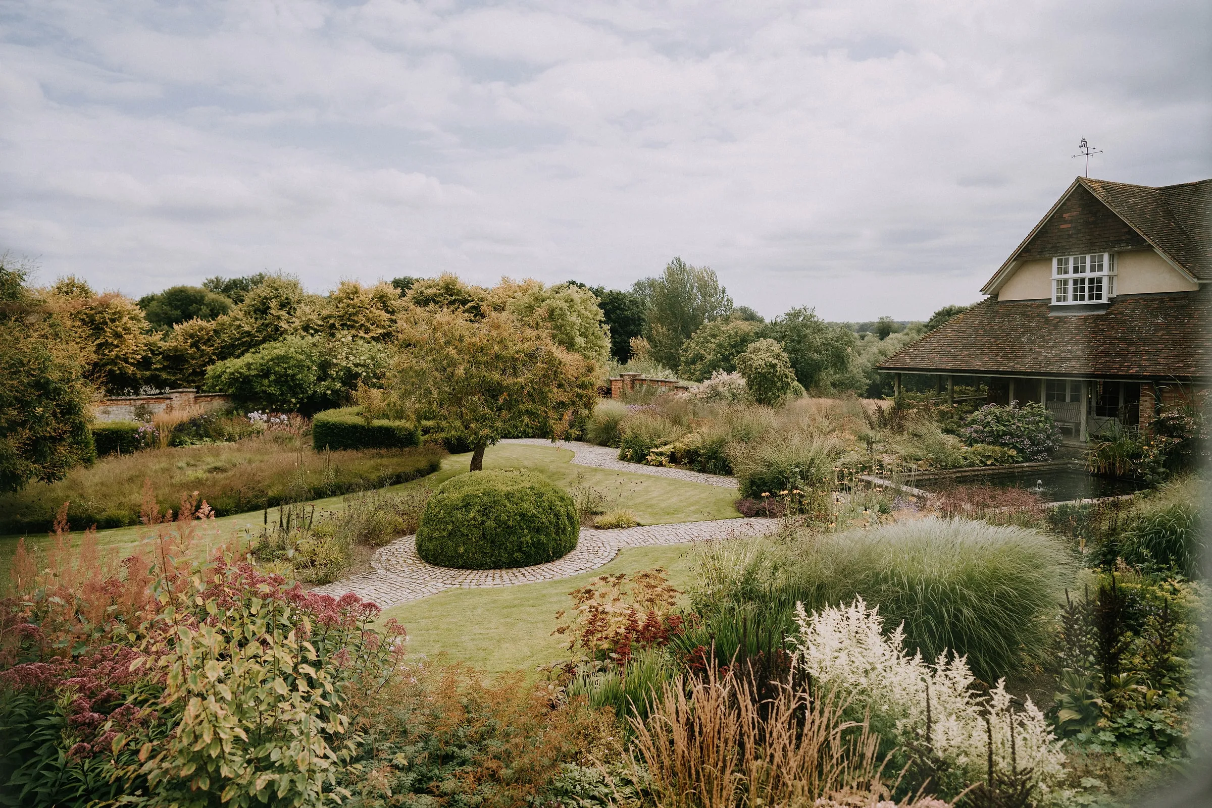 The courtyard garden from above, with a clipped box dome, curving paths and tall grasses