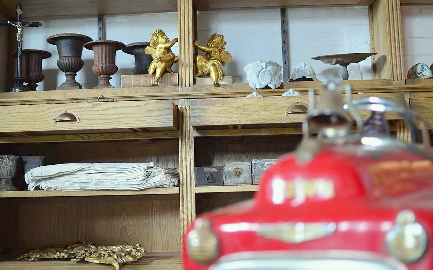 Shelves of antique urns and cherubs in the shop